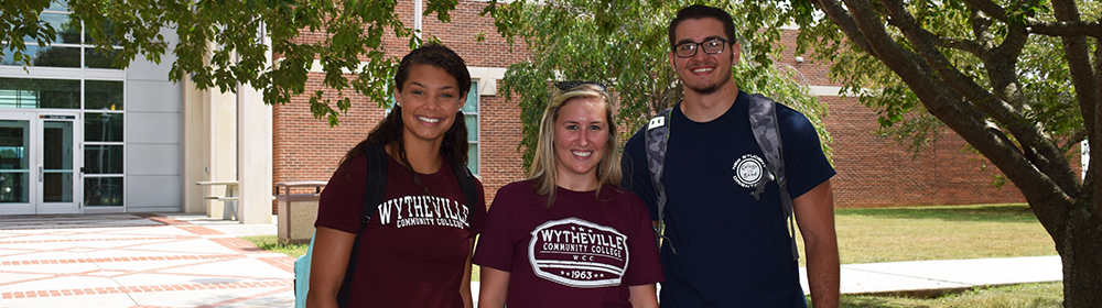Three students standing outside of Smyth Hall on WCC campus
