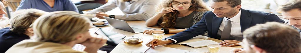 Employees around a table during a meeting