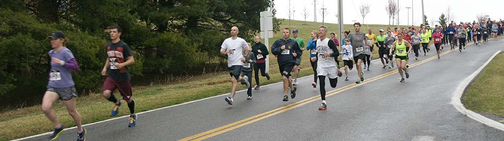 Runners sprinting from the start of the WCC 5k for scholarships
