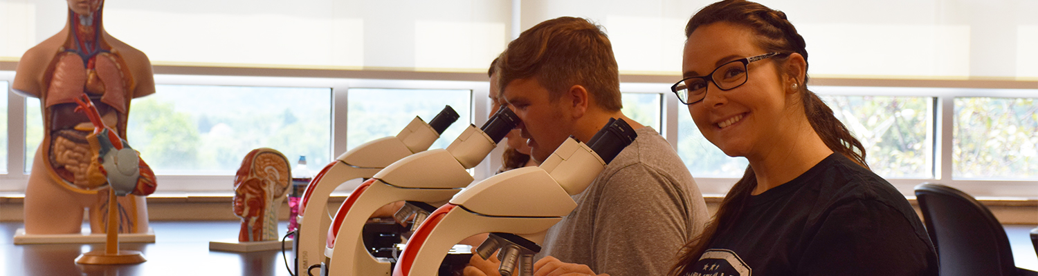 Students using microscopes in the Biology lab
