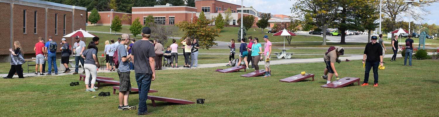 Students playing cornhole on campus