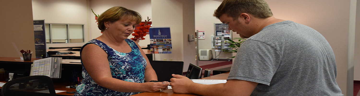 Staff helping a student