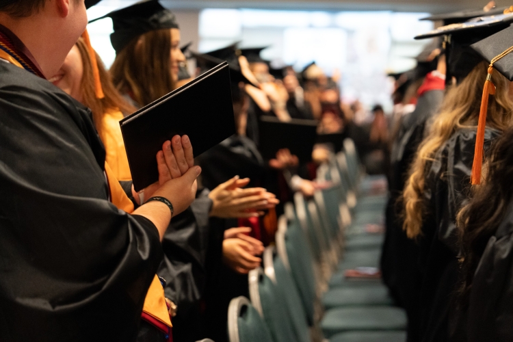 Graduates holding diplomas